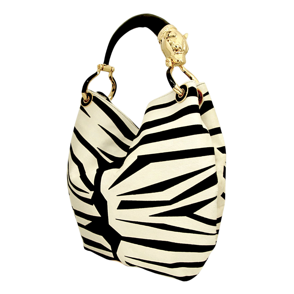 Three-quarter view of a large zebra-print hair-on leather bag with black and gold panther sculpture handle.