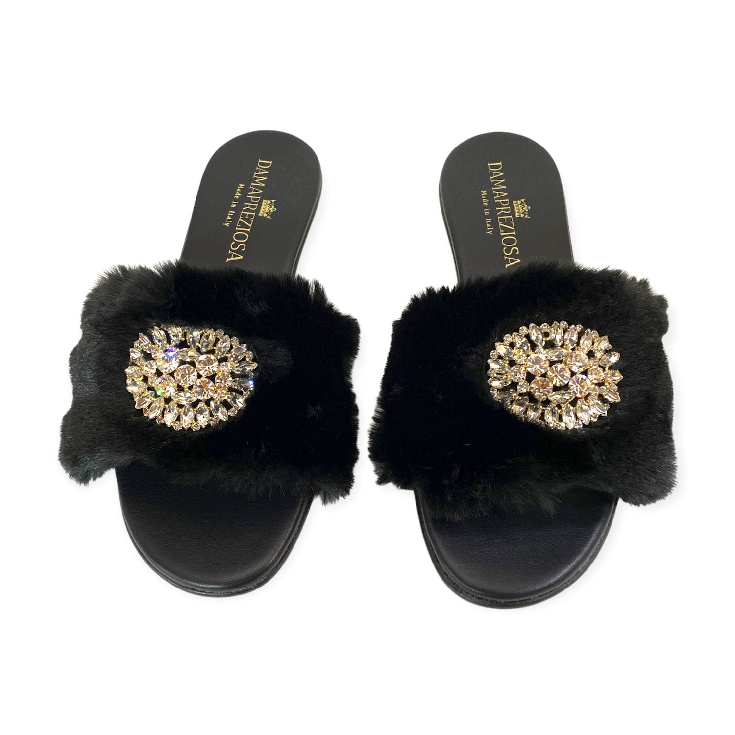 Made in Italy. Black vegan faux fur and vegan leather embellished with white crystals. Elegant padded insoles in soft black vegan leather to add the comfort you deserve. 2 cm. heel covered in black vegan leather.  Damapreziosa logo engraved on soles and insoles. Glittery sole.  PETA approved vegan product, made with non-leather materials following our cruelty-free ethics. Plastic-free, recycled paper boxes and packaging, and organic cotton dust bag.