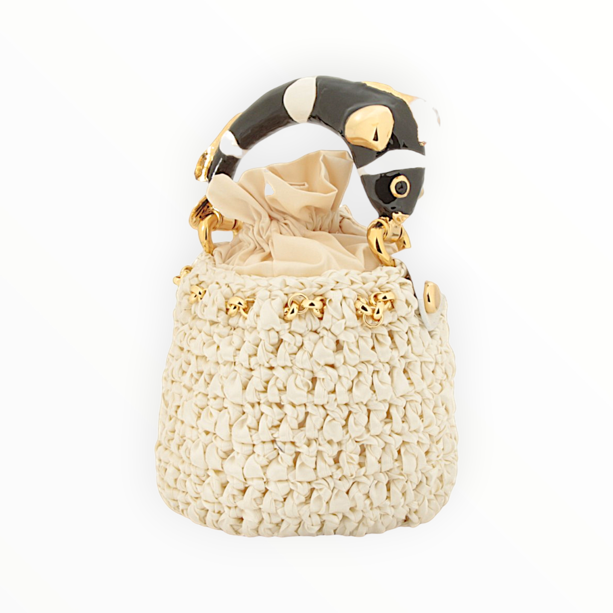 Three-quarter view of INGA Nemo Black & White Italian bucket bag with sculptural fish handle and off-white crocheted satin body
